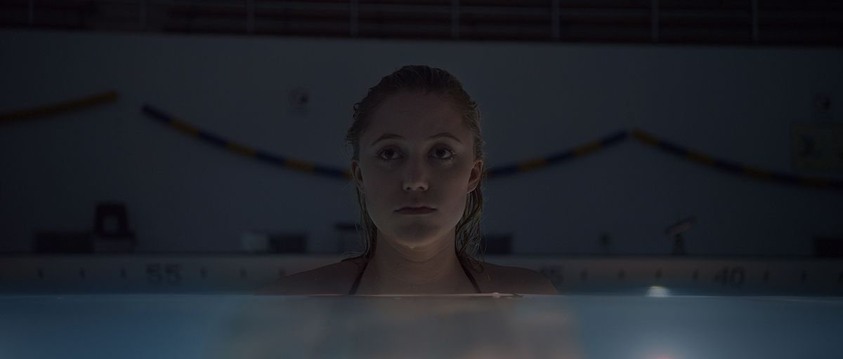 A woman waits in a swimming pool in It Follows