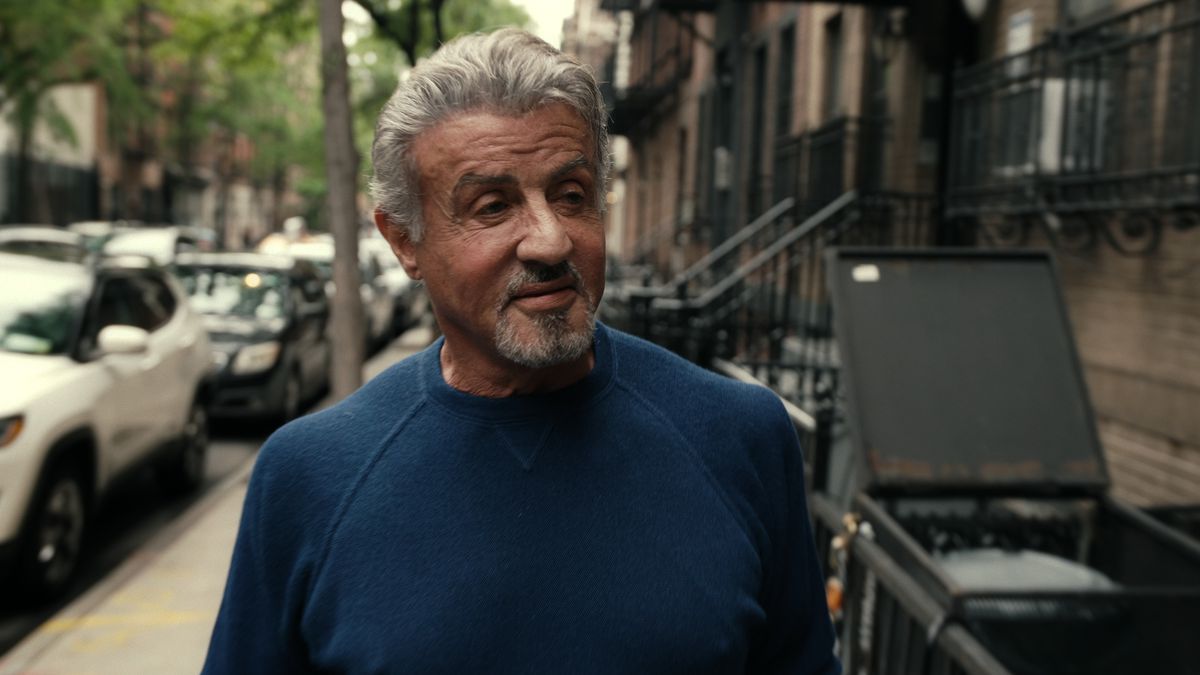 Sylvester Stallone walking through a neighborhood in Sly.