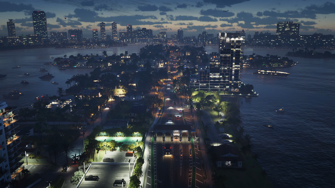 An aerial shot of Vice City at night, with skyscrapers lit up around its seafront.