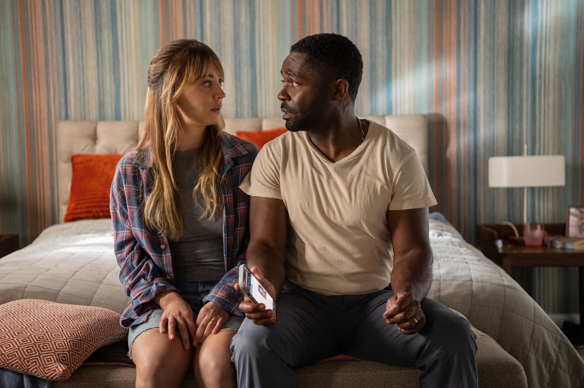 (L-R) Kaley Cuoco and David Oyelowo sitting on a bed with a visible look of concern in Role Play.