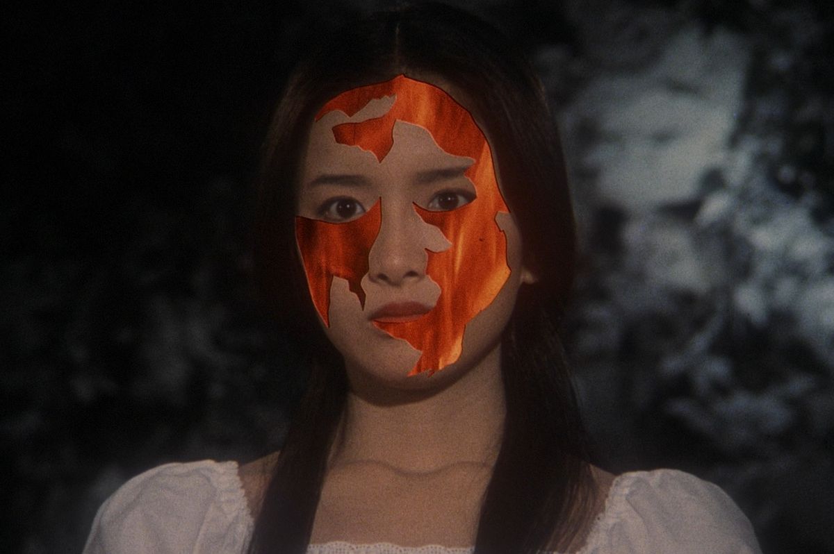 A woman’s face with some of the skin replaced with a fiery video effect in 1977’s House