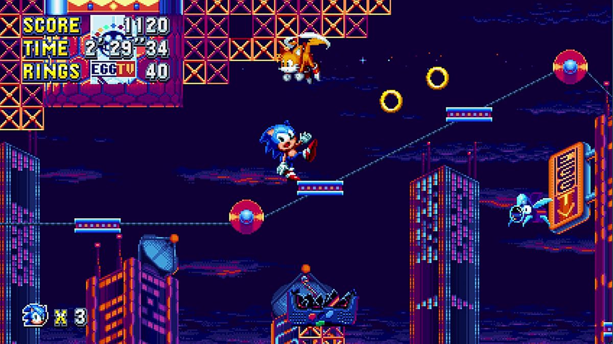 Sonic the Hedgehog balances precariously on a moving platform while Tails hovers overhead in a screenshot from Sonic Mania