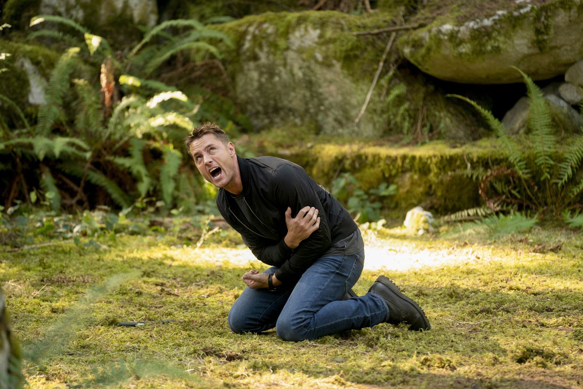 Colter Shaw, the Tracker, kneels in the woods in pain in the CBS drama Tracker