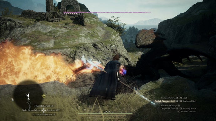 Dragons Dogma 2 preview screenshot showing combat outside in the grassy hills with flames and a staff