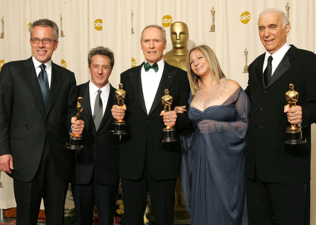 Tom Rosenberg, Dustin Hoffman, Clint Eastwood, Barbara Streisand, and Albert S. Ruddy pose backstage during the 77th Annual Academy Awards.