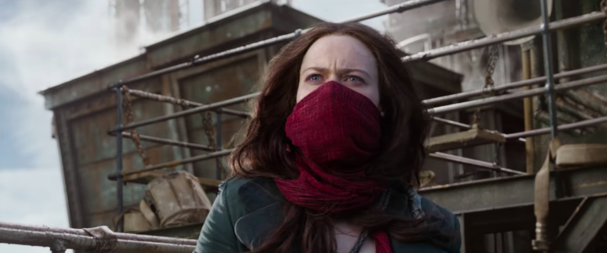 Screencap from the first trailer of Peter Jackson’s Mortal Engines, featuring a woman with a red scarf around the lower half of her face