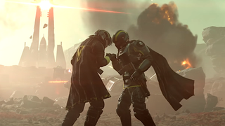 Two Helldivers share a tender moment in Helldivers 2, while Automatons ravage the landscape behind them with explosions.