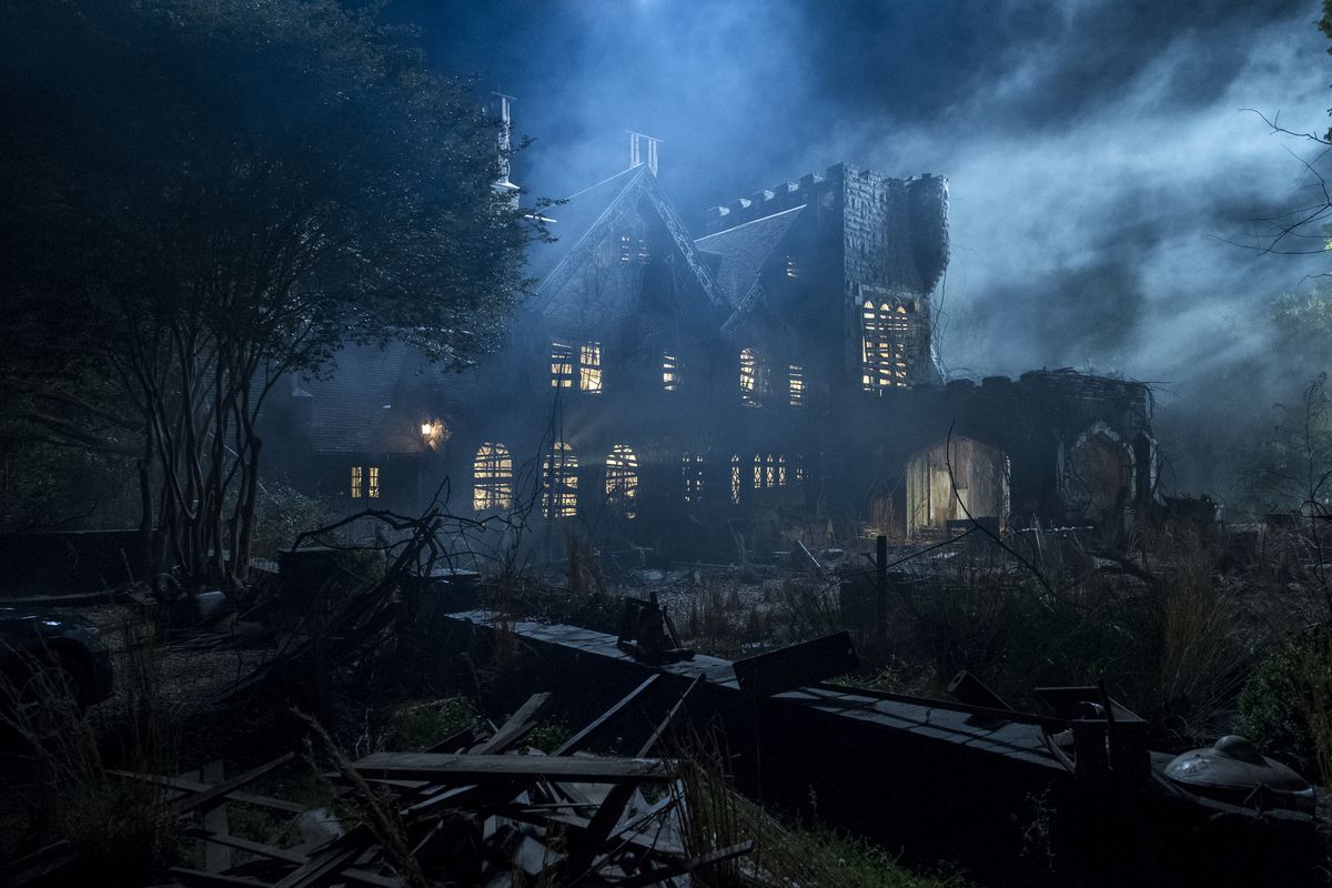 Hill House surrounded by fog and moonlight in The Haunting of Hill House.